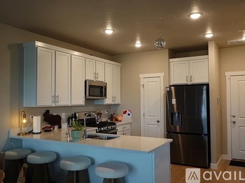 A kitchen with a blue bar and white cabinets.