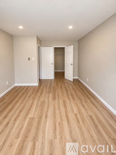 A room with wooden floors and a white door.