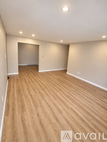 A room with wooden flooring and a logo that reads "avail" on the bottom right.