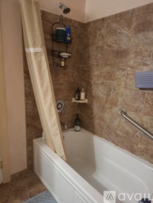 A bathroom with a tub and a shower.