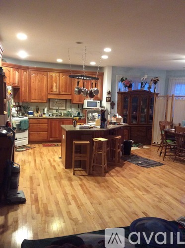 A kitchen with wooden floors and wooden cabinets.