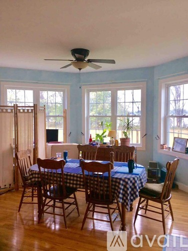A dining room with a table set for six.