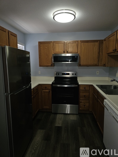 A kitchen with a black refrigerator and stove.