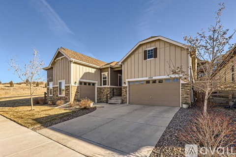 A two-story house with a garage is for sale.