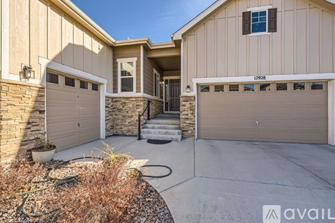 A house with two garages and a driveway.