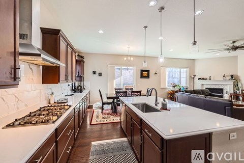A modern kitchen with dark wood cabinets and a white countertop.