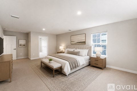A well-lit bedroom with a large bed and a window.