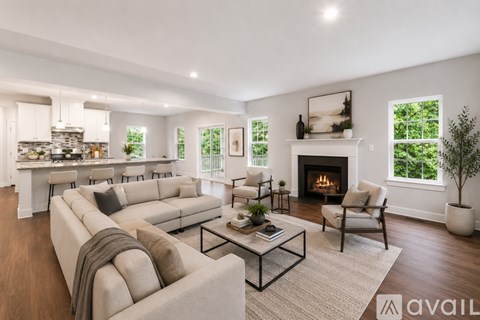 A modern living room with a fireplace and a large couch.
