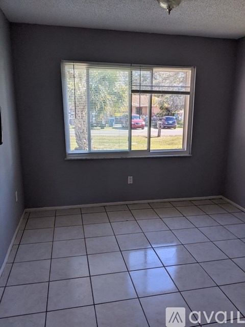 A room with a large window and tiled floor.