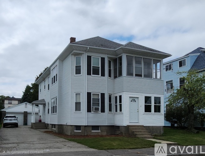 A two-story house with a white exterior and a blue house in the background.