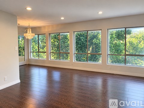 A room with wooden floors and a chandelier.