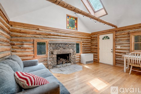 A cozy living room with a fireplace and a couch.