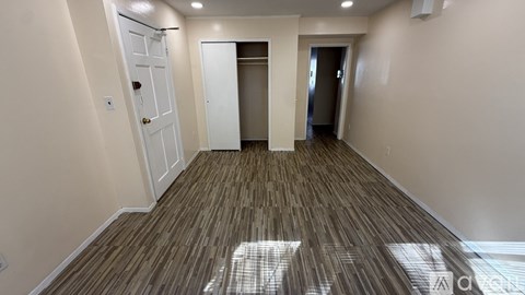 A room with a wooden floor and white walls.