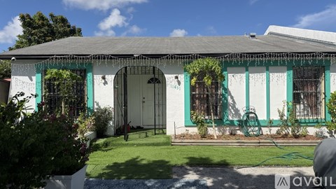 A white house with green trim and a white door.