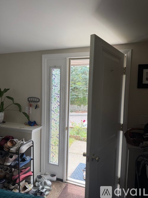 A white door with a glass window is open.