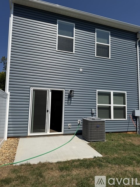 A house with a blue siding and a green hose.