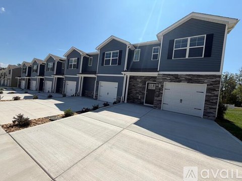 A row of houses with garages are available for rent.