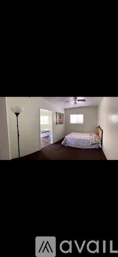 A bedroom with a bed, a dresser, and a window.