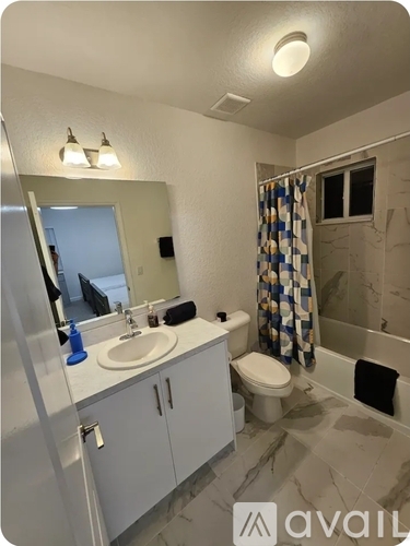A bathroom with a sink, toilet, and shower.