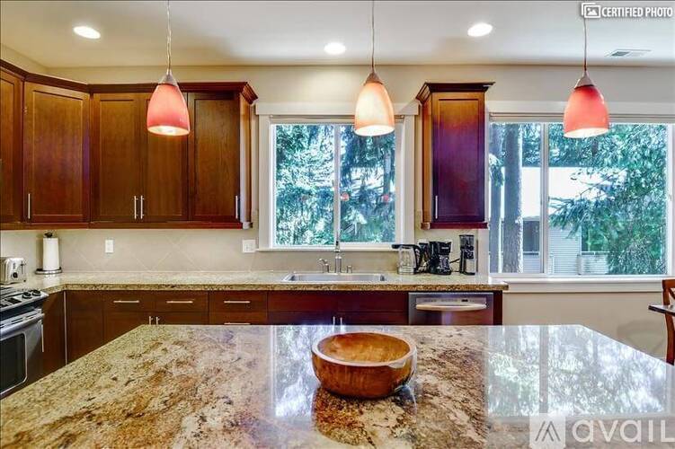 A kitchen with wooden cabinets and granite countertops.
