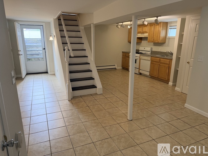 A living room with a staircase leading to the upper floor.