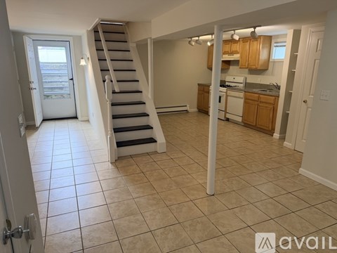 A living room with a staircase leading to the upper floor.