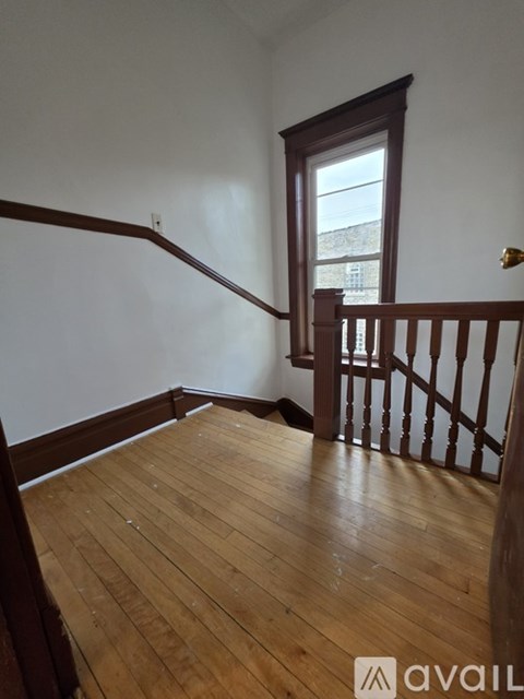 A room with wooden floors and a window.