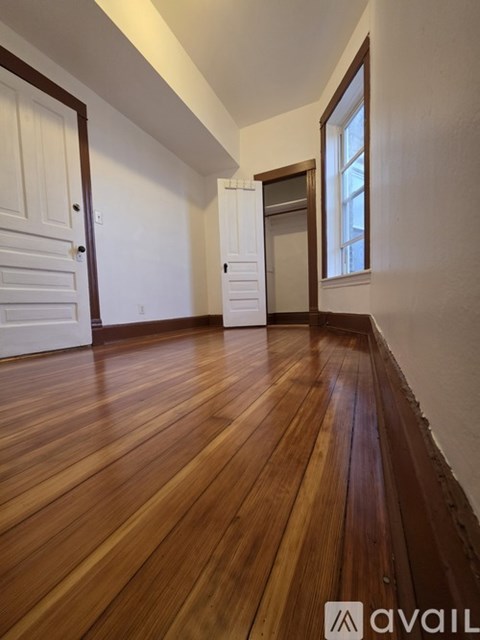 A room with wooden floors and white walls.