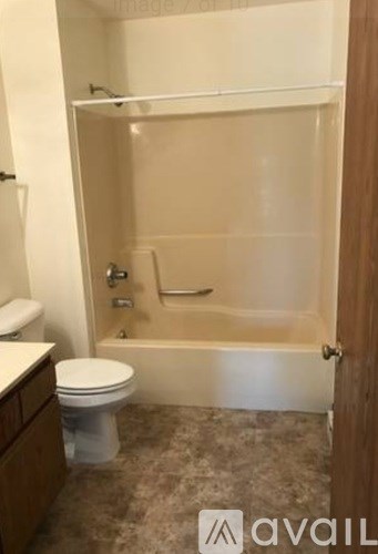 A bathroom with a toilet, tub, and sink.