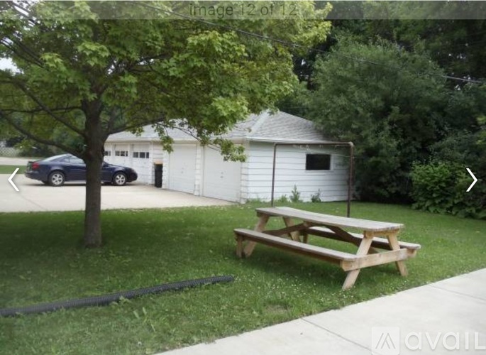 A picnic table is in the foreground of a grassy area.