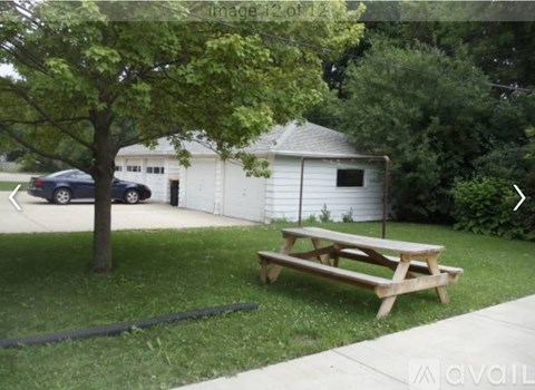 A picnic table is in the foreground of a grassy area.
