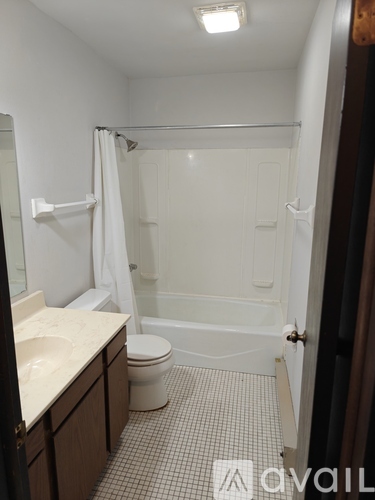 A bathroom with a toilet, sink, and bathtub.