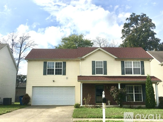 A two-story house with a garage is for sale.