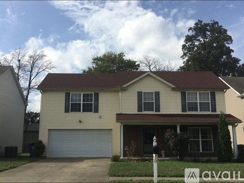 A two-story house with a garage is for sale.