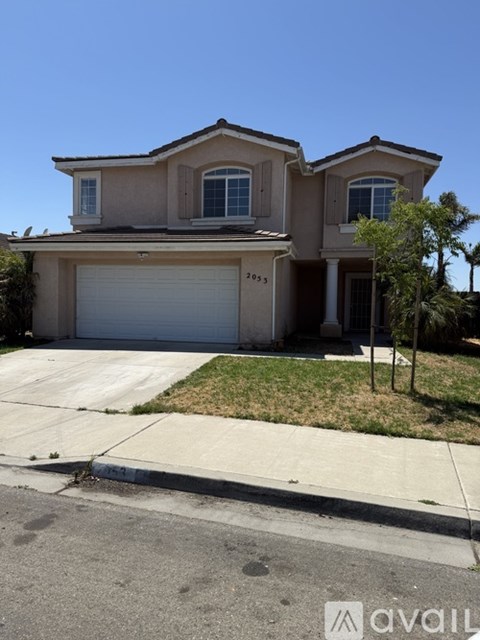 A two-story house with a garage is for sale.