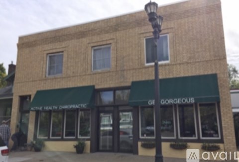 A building with a green awning that says "Gorgeous" on it.