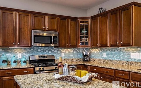 A kitchen with wooden cabinets and a granite countertop.
