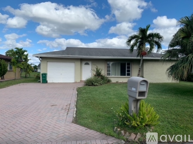 A house with a driveway and a mailbox in front.