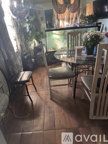 A dining room with a glass table and chairs.