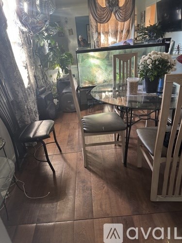 A dining room with a glass table and chairs.
