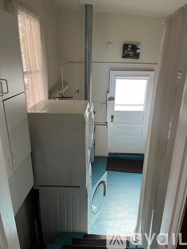 A small kitchen with a refrigerator and a sink.