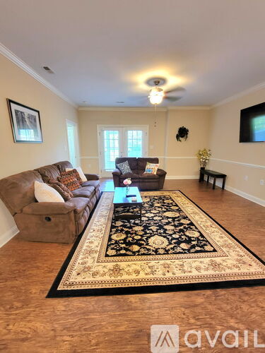A living room with a rug and a couch.