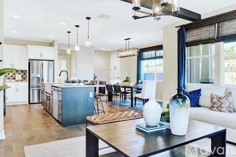 A modern kitchen with a dining table and chairs.