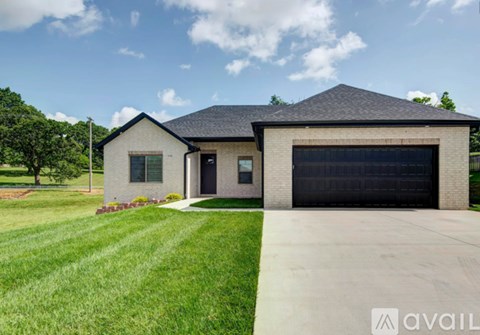 A house with a black garage door is for sale.