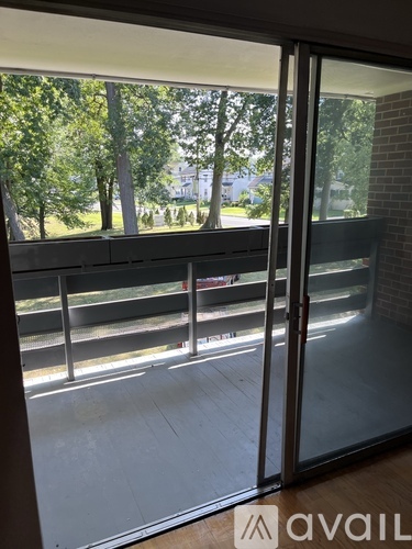 A view from inside a building looking out through a sliding glass door.