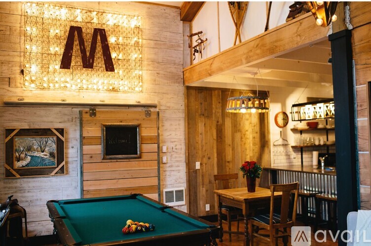 A pool table with a green cloth and a billiard ball on it.