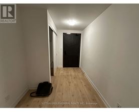 A hallway with a suitcase on the floor.
