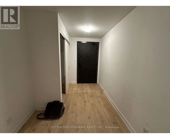 A hallway with a suitcase on the floor.