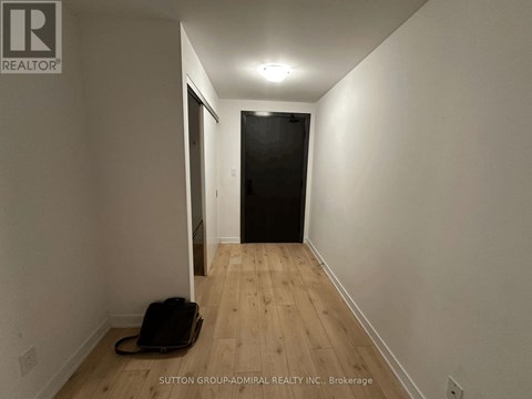 A hallway with a suitcase on the floor.