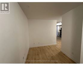 A room with wooden flooring and white walls.